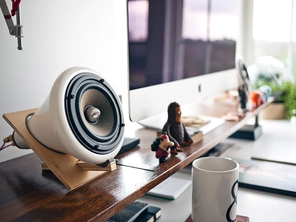 Office desk with computer and music player (Unsplash).jpg