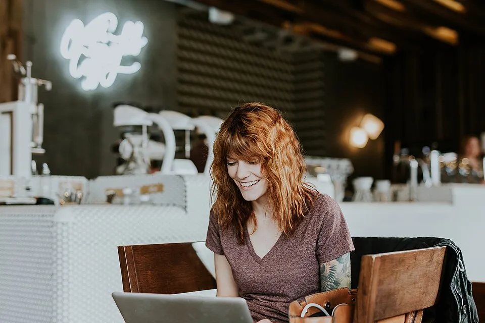Tattooed woman with laptop (Unsplash).jpg